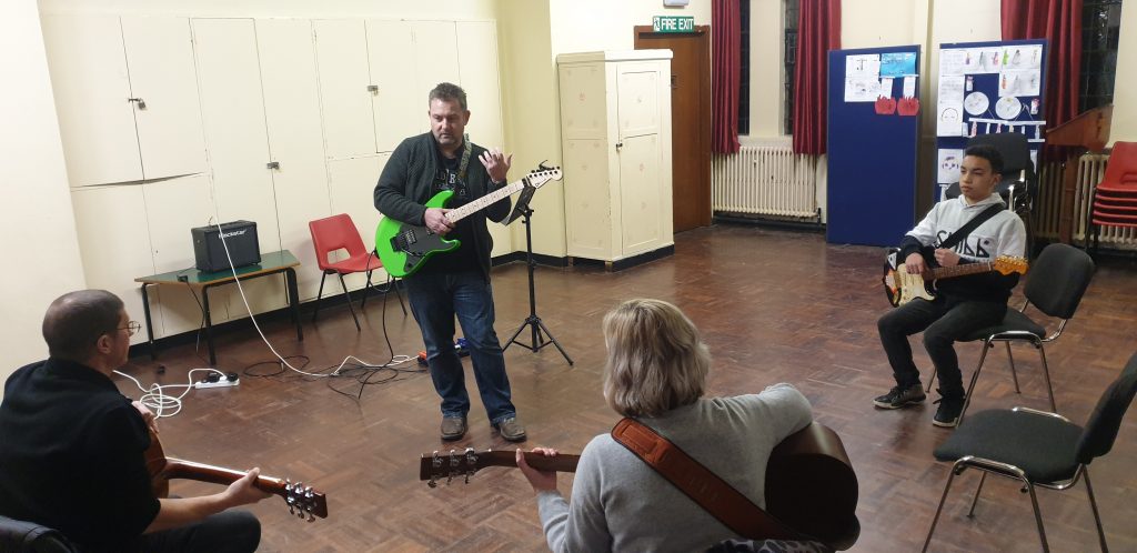 Chris Dixon with a guitar group